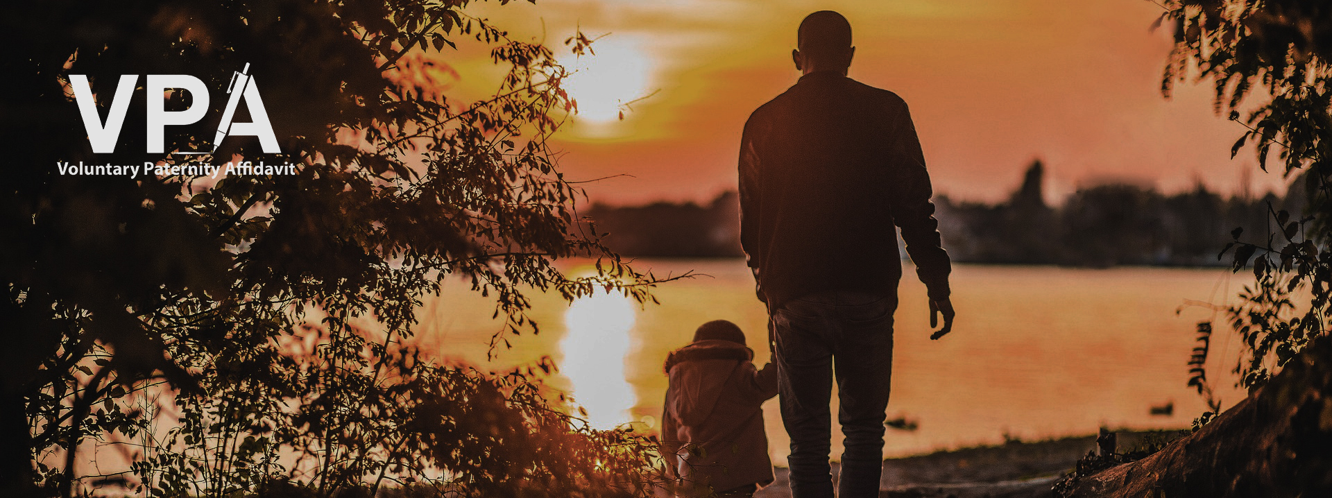 A father and child watching a sunset.