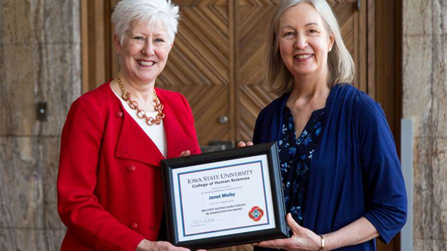 Janet Melby receiving an award from Dean Jolly