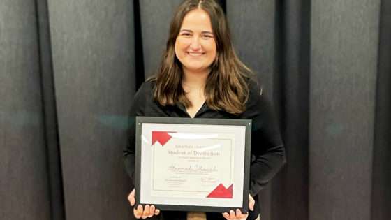 Hannah posing with her award