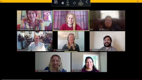 A screenshot from a Service Training Zoom meeting. Everyone is smiling at their webcams.