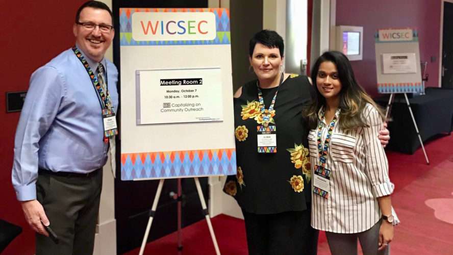 PIAL Staff pose in front of their sign at WICSEC