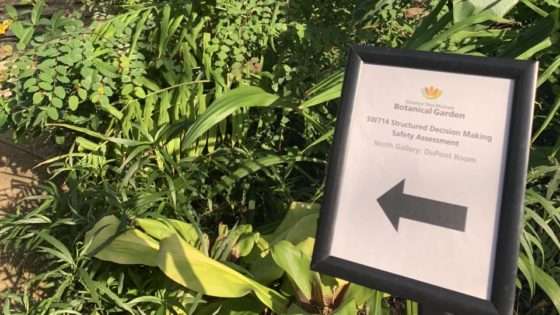A sign posted in the botanical garden directing event goers to the training.