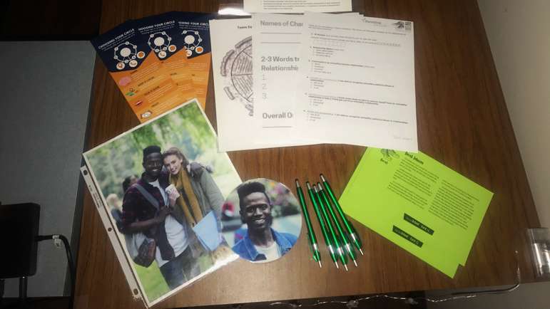 A photo of the pretend funeral hom display PIAL uses as part of its Teen Dating Violence Awareness program. The display includes a photo of the pretend victim and information about him.