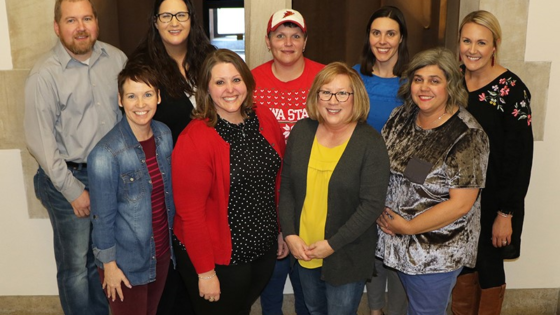 The 2020 conference planning team is looking up and smiling at the camera